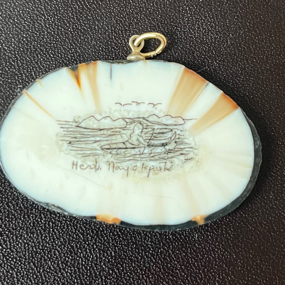 Scrimshaw pendant with etchings fisherman